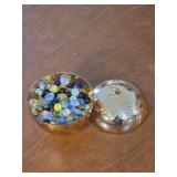 Glass yellow Apple full of marbles