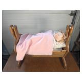 Porcelain doll, rocking bassinet