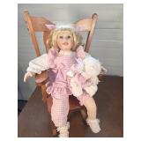 Porcelain doll in rocking chair