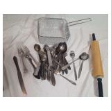Kitchen Utensil Lot Featuring Stainless Steel Flatware, Rolling Pin, and Wire Basket