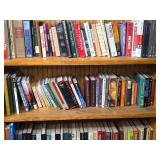 Assorted Hardcover and Paperback Books on Various Shelves