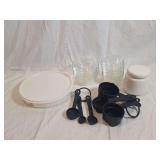 Kitchen Utensil Lot Featuring Glass Bowls, Plastic Measuring Cups and Spoons, Ceramic Container, and White Plastic Lid