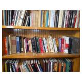 Assorted Hardcover and Softcover Books on Multiple Shelves