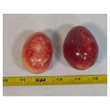 Two Polished Stone Decorative Eggs in Red and Pink Mineral Formations