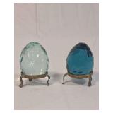 Two Faceted Blue Glass Eggs with Metal Tri-Foot Stands