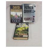 Three Hardcover Novels by David Baldacci, Patricia Cornwell, and Clive Cussler