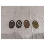 Four Oval Metal Numbered Tags stamped 26, 33, 6, and 24