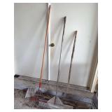 Three Garden Tools Including Leaf Rake, Metal Floor Scraper, and Pitchfork Handle