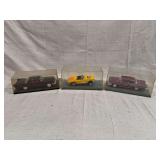 Group of Three Model Cars in Display Cases