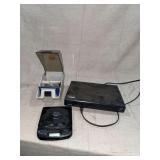 Electronics Group Including Sanyo Blu-Ray Player, Lenoxx Sound CD Player, and Floppy Disk Holder with Disks